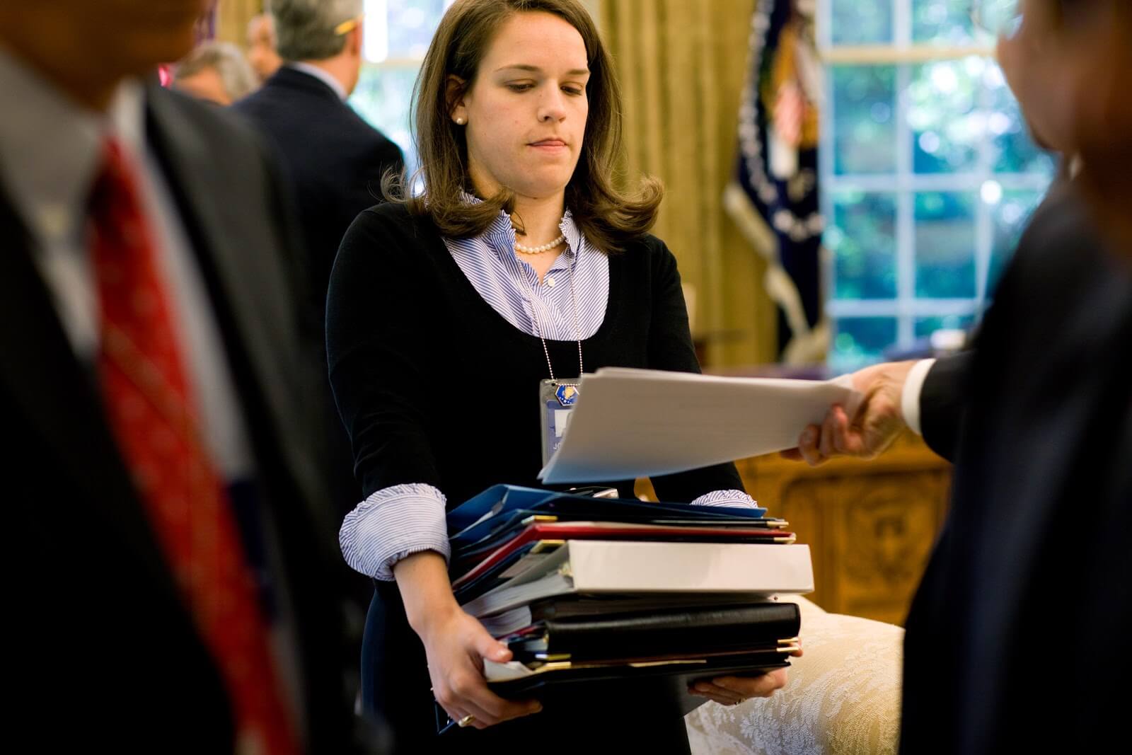 Katie Johnson President Obamas personal secretary collects documents after a morning Oval Office briefing